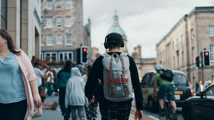 Man with headphones walking on the street.