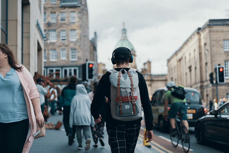 Man with headphones walking on the street.