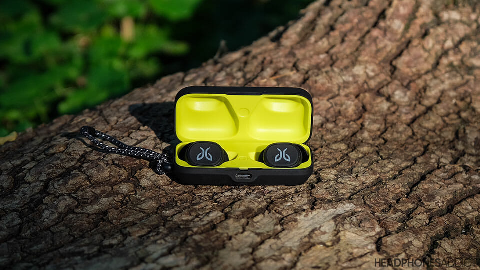 Jaybird Vista true wireless earbuds on a wooden log