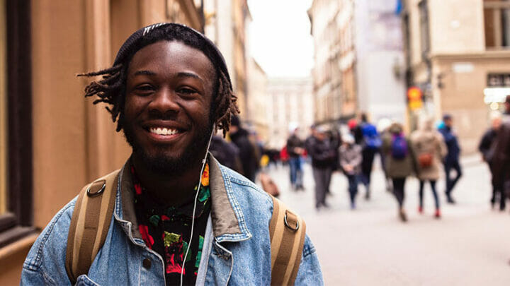 Man listening to headphones on street