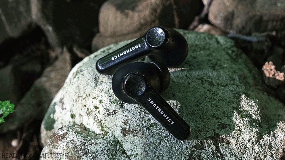 TaoTronics Soundliberty P10 Pro earbuds on a stone