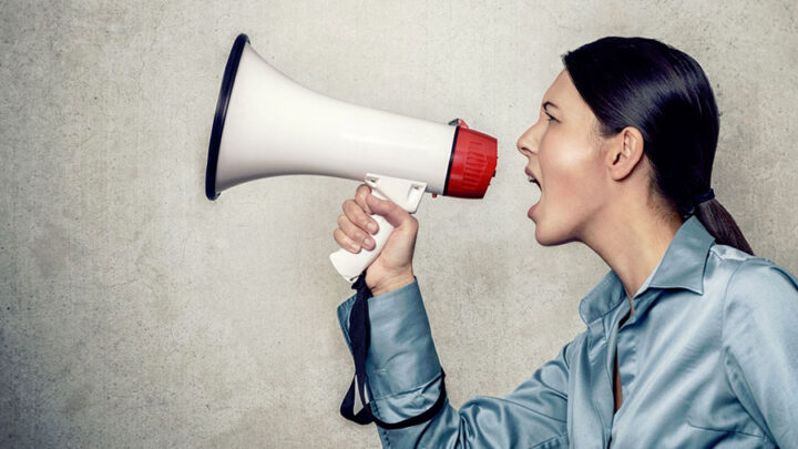 woman talking to a megaphone making noise