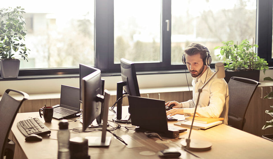 working in office with headphones